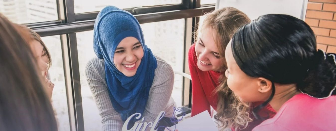 A group of multi-cultural women collaborating.