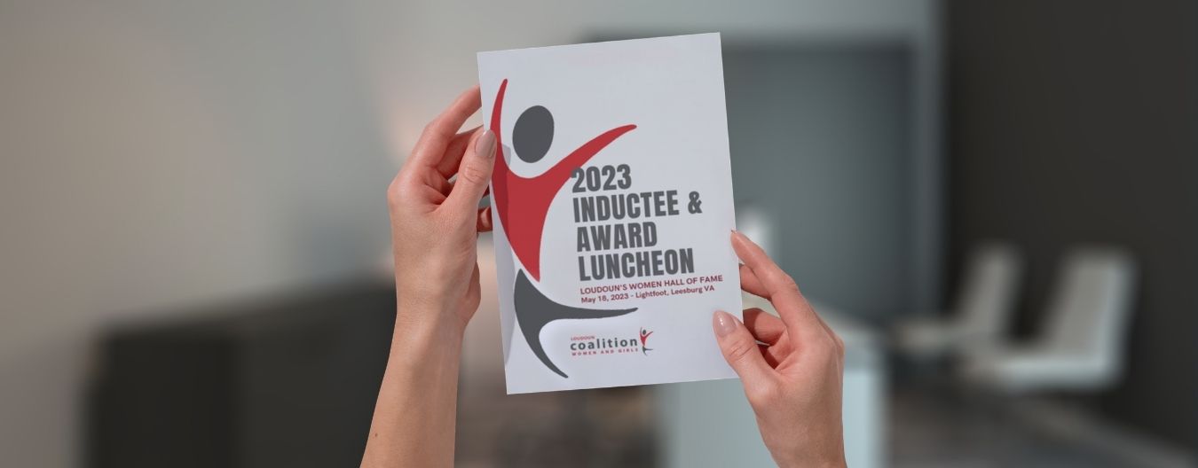 9 – LCWAG LCWAG Inducts Eight into Loudoun Women’s Hall of Fame Hands holding a program booklet for the 2023 Inductee & Award Luncheon for Loudoun’s Women Hall of Fame.
